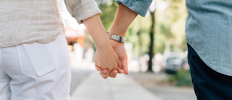 Couple walking down a street.